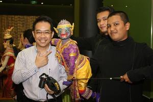 Primary view of object titled '[Man poses with Thai puppet]'.
