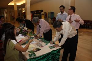 Primary view of object titled '[People fill out forms at UNT alumni party in Bangkok, 1]'.