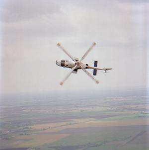 Primary view of object titled '[Bell Helicopter in mid-flip rotation]'.