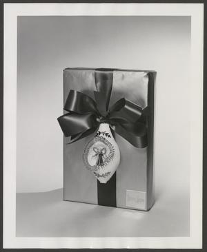 Primary view of object titled '[Product photograph of Christmas gift box embellished with an angel ornament]'.