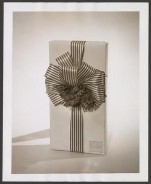 Primary view of object titled '[Sepia product photograph of a Neiman Marcus wrapped gift box]'.