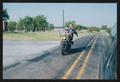 Thumbnail image of item number 1 in: '[A motorcycle riding to the side of a driving van: Lone Star Ride 2002 event photo]'.