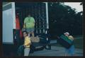 Photograph: [Volunteer trio loading a moving truck with bags: Lone Star Ride 2002…