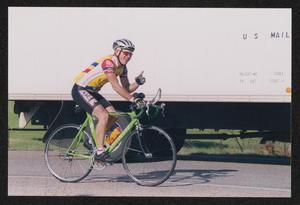Primary view of object titled '[Cyclist Ray Allen passing a U.S mail truck: Lone Star Ride 2002 event photo]'.