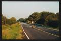 Thumbnail image of item number 1 in: '[Cyclist riding no hands down a rural road: Lone Star Ride 2002 event photo]'.
