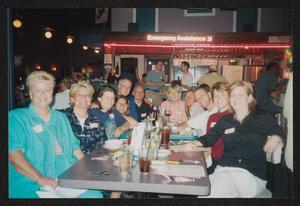 Primary view of object titled '[11 people seated around a restaurant table: Lone Star Ride 2003 event photo]'.