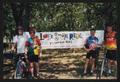 Photograph: [Four cyclists posing by an LSR banner: Lone Star Ride 2003 event pho…