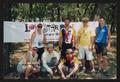 Primary view of [Group of 7 standing by an LSR banner in a park, 2: Lone Star Ride 2003 event photo]