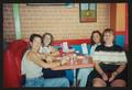 Photograph: [Four women seated at a red booth table: Lone Star Ride 2003 event ph…