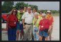 Primary view of [Janie Bush and eight others standing in a parking lot: Lone Star Ride 2003 event photo]