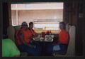 Photograph: [Three crew members eating breakfast in a wooden booth: Lone Star Rid…