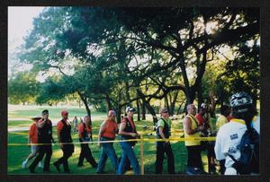 Primary view of object titled '[A group of motorcyclists walking in a line: Lone Star Ride 2003 event photo]'.