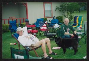 Primary view of object titled '[Two men sitting among empty lawn chairs: Lone Star Ride 2004 event photo]'.