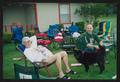 Thumbnail image of item number 1 in: '[Two men sitting among empty lawn chairs: Lone Star Ride 2004 event photo]'.