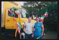 Primary view of [Two volunteers posed by a decorated Penske truck: Lone Star Ride 2004 event photo]