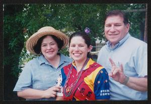 Primary view of object titled '[Family of three posing with cyclist daughter: Lone Star Ride 2004 event photo]'.
