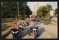 Photograph: [Motorcycles and cyclists passing Oak Lawn United Methodist: Lone Sta…