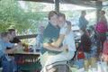 Photograph: [Two individuals posing in a whole body embrace on a restaurant patio…