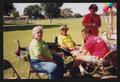 Photograph: [Four seated crew members: Lone Star Ride 2001 event photo]