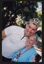 Primary view of [Cyclist in a tiara and Janie Bush embracing: Lone Star Ride 2005 event photo]