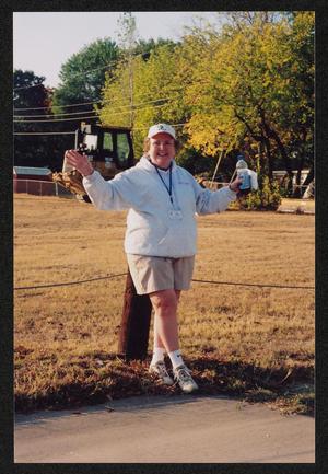 Primary view of object titled '[Volunteer in an LSR sweatshirt with her arms out: Lone Star Ride 2005 event photo]'.