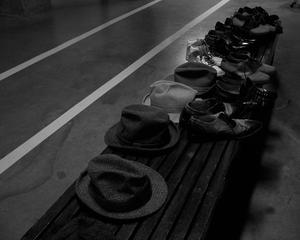 Primary view of object titled '[Hats and shoes on a bench]'.