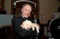 Photograph: [Man 2 holds auction puppy at 2005 Black Tie Dinner]