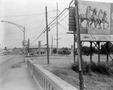 Photograph: [Photograph of a street and a billboard in Fort Worth]
