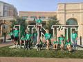 Primary view of [Class of 2025 students posing in front of UNT letter installation at the Welcome Center]