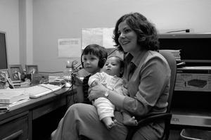 Primary view of object titled '[Concha Neeley with her children in UNT office]'.