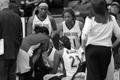 Photograph: [UNT women's basketball team surrounds injured teammate]