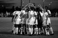Photograph: [UNT soccer team huddles on the field]
