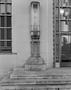 Photograph: [An art deco style column in front of a building]