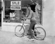 Primary view of [Photograph of a man with his bike]