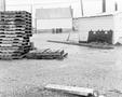 Photograph: [Photograph of an area with a building and pallets]