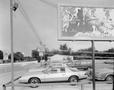 Photograph: [Automobiles under a billboard]