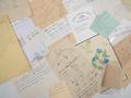 Primary view of [Closeup of a collection of assorted handwritten notes and drawings]