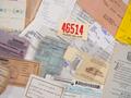 Photograph: [Closeup of a collection of assorted invoices, receipts, and tickets]