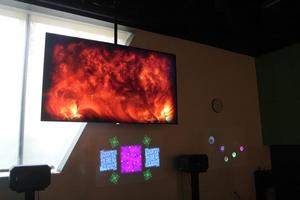 Primary view of object titled '[Tv scree with image of fire, College of Music at the Perot Museum]'.