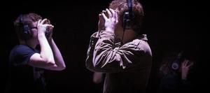 Primary view of object titled '[Two people wearing headphones at the Intermedia Performance Art Class Concert]'.
