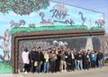 Photograph: [Band members in front of Nifty Nut House mural]