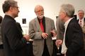 Photograph: [Gene Scheer, Jerry McCoy, and David Itkin conversing at the Jake Heg…