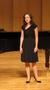 Primary view of [Singer wearing black dress performing at the Student recital during Jake Heggie's residency, 3]