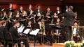 Photograph: [Conductor, choir, and musicians at Sounds of the Holidays]