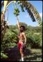 Photograph: [Ruben reaching for bananas on a tree]