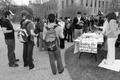 Photograph: [Students crowd table at immigration protest, side view]