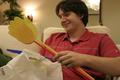 Photograph: [Man holds fly swatters during Aerie Yearbook staff party]