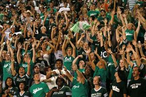 Primary view of object titled '[Crowd members cheer at UNT football game, 2005]'.
