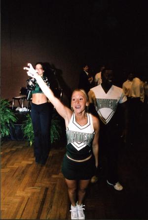 Primary view of object titled '[Cheerleaders wear new uniforms at UNT rebrand unveiling]'.