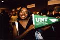 Primary view of [Student poses with new UNT pennant]